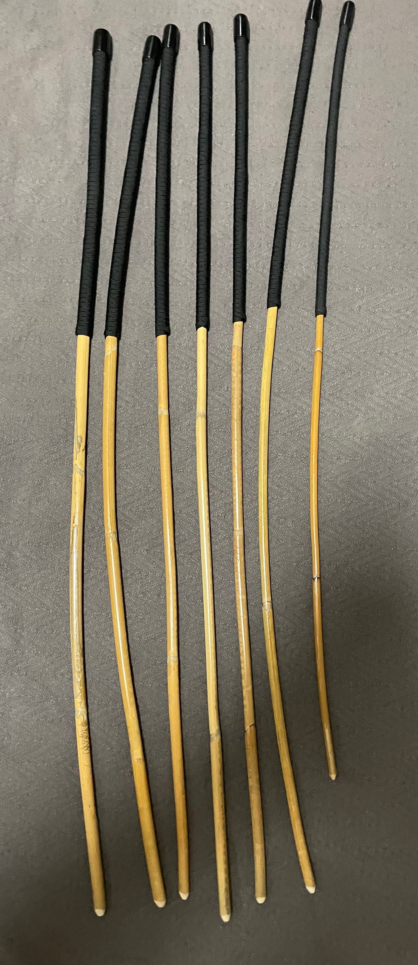 Kooboo Rattan Canes / School Canes Set of 7 Rattan Punishment Canes - 72 - 87 cms Length - Black Paracord Handles - Stripewell Canes