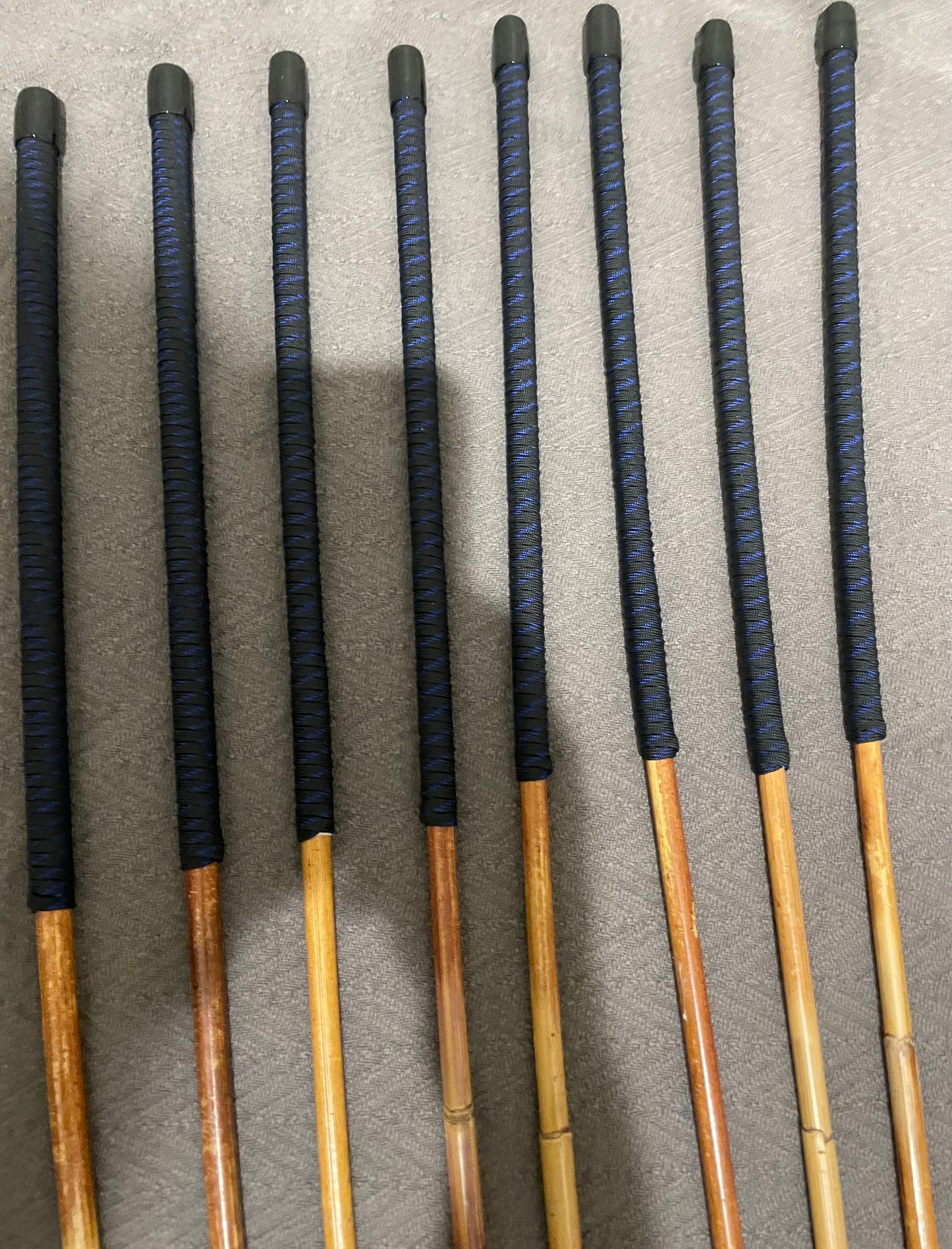 Set of 8 Natural Dragon Canes / BDSM Canes / School Canes SECONDS SET - 95 cms L -& 8.5 - 12.5 mm D - Blue Streak Paracord Handles - Stripewell Canes