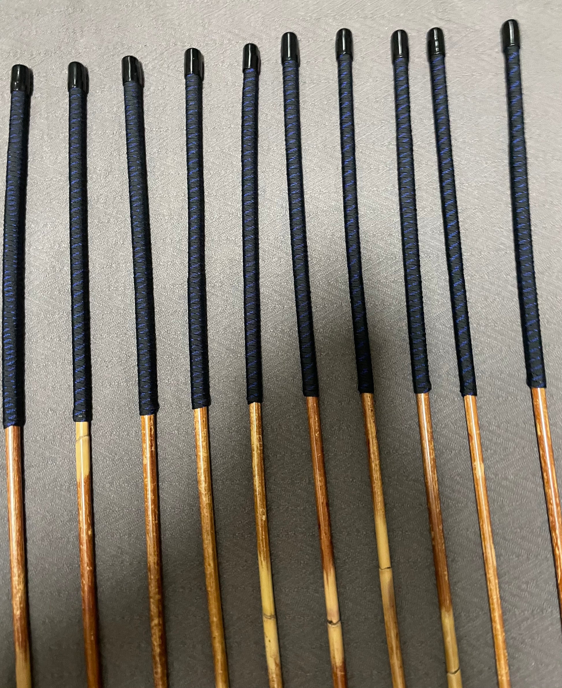 Set of 10 Natural Dragon Canes / BDSM Canes / School Canes SECONDS SET - 95 cms L -& 8.5 - 12.5 mm D - Blue Streak Paracord Handles - Stripewell Canes