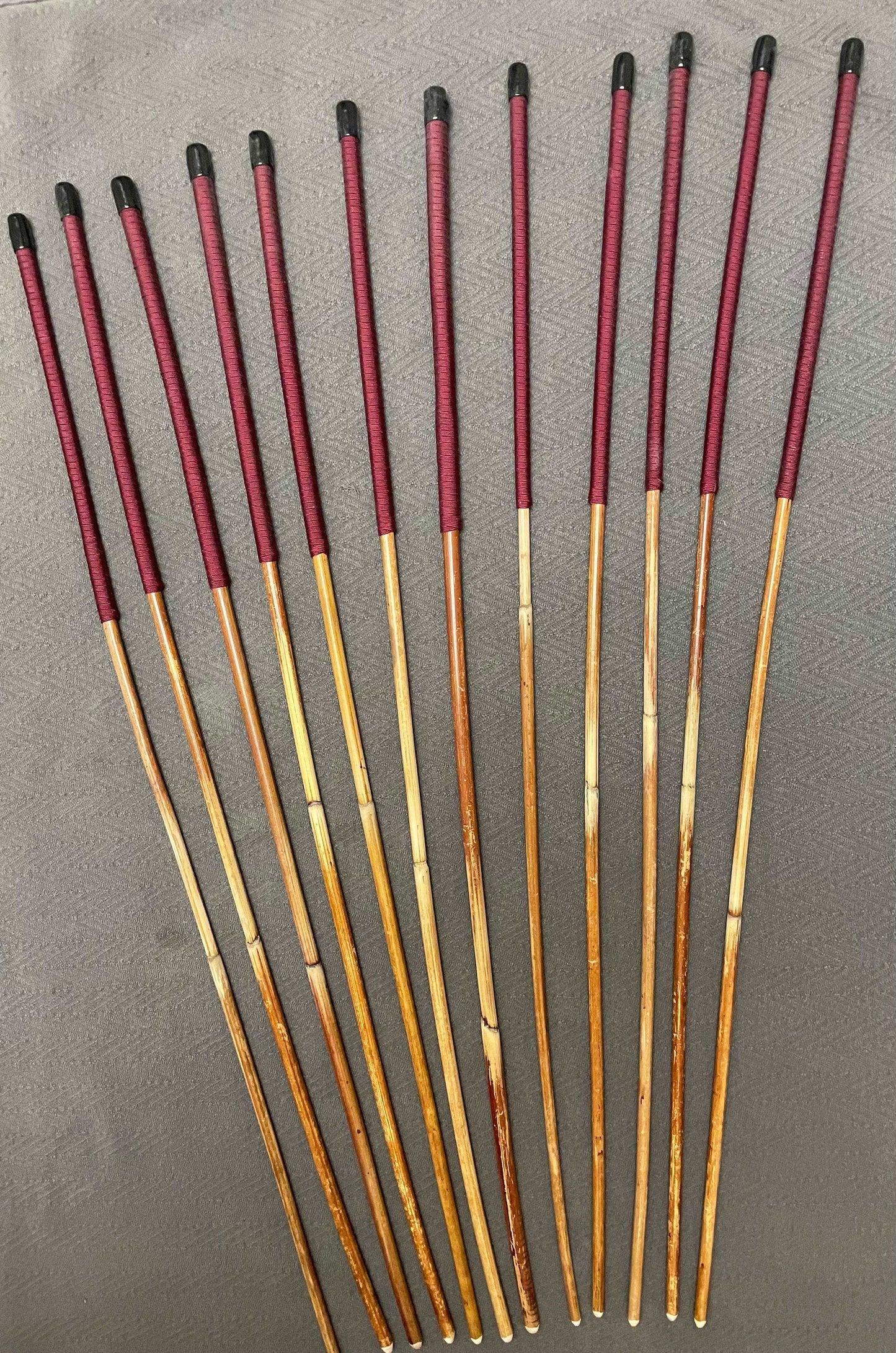 Set of 12 Natural Dragon Rattan Punishment Canes / School Canes / Whipping Canes - SECONDS SET - 95/100 cms Length - BURGUNDY HANDLES - Stripewell Canes