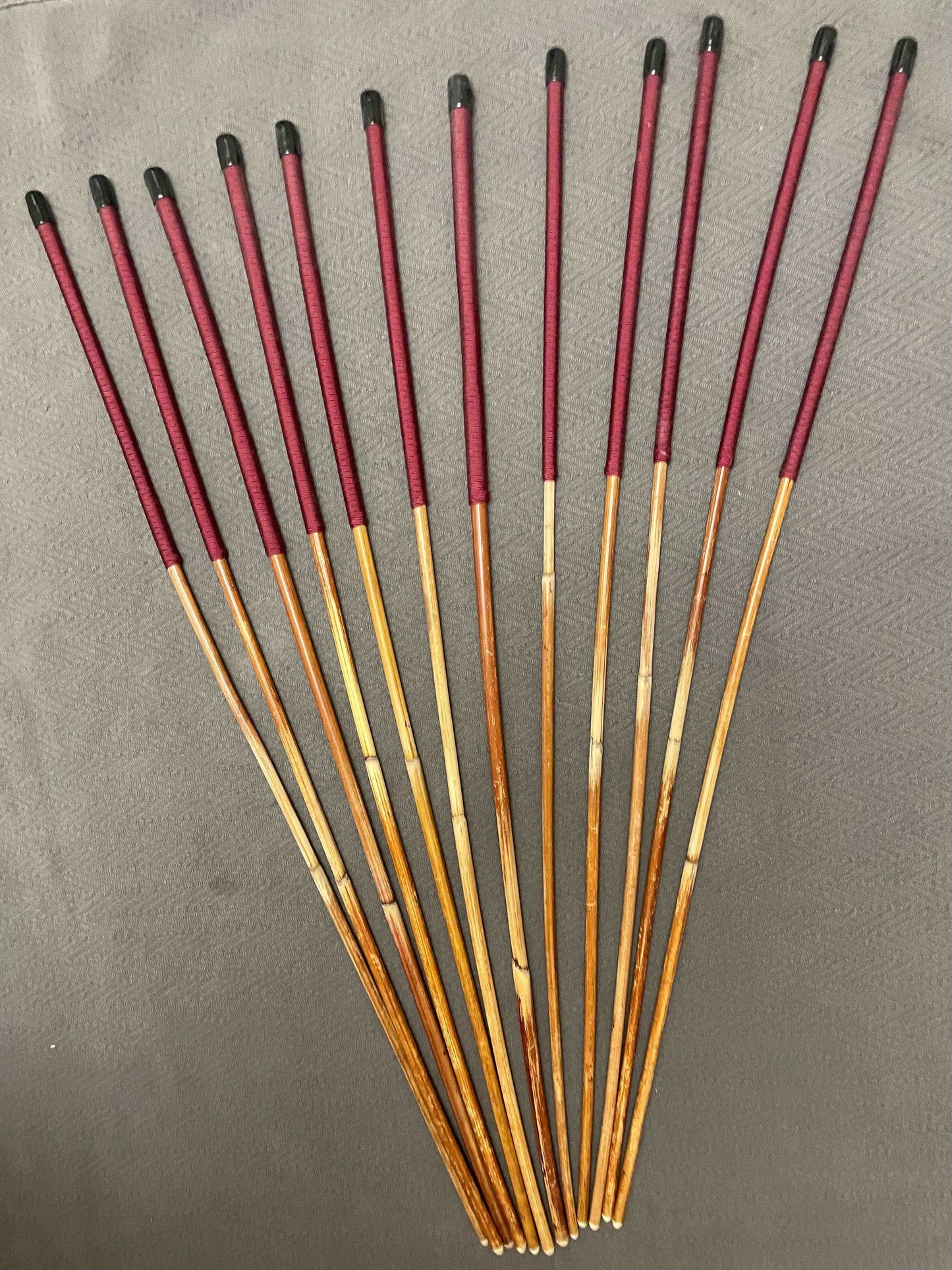 Set of 12 Natural Dragon Rattan Punishment Canes / School Canes / Whipping Canes - SECONDS SET - 95/100 cms Length - BURGUNDY HANDLES - Stripewell Canes